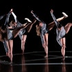 A photograph of multiple people engaged in a dance performance.