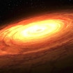 A screenshot of an animation that shows an artist’s impression of an accretion disk rotating around a central unseen supermassive black hole (SMBH). The overall image looks like a gigantic circle in space with concentric 