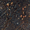 A photograph of the Ophiuchus star-forming complex, an area in outer space with multiple stars of varying sizes and colors.