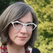 Portrait photo of Julianne Dalcanton against a forest scene.