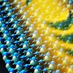 A digital illustration of two surfaces each made up of interconnected 3-D molecule structure models.