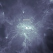 A digital photo of a misty, quasar-like formation in what appears to be outer space. A plus-shaped crosshairs is at the center of the formation and surrounded by a dotted circle. White text above this circle reads, 