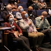 A photograph of David Spergel amongst other people in seats in an auditorium.