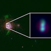 An image of a galaxy with bright blobs stacked on top of one another in the middle. An inset shows a close up of the two blobs, which are the locations of supermassive black holes.