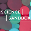 Science Sandbox logo in front of multicolored circles