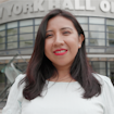 woman standing in front of new york hall of science
