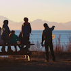 7 people enjoying views of mountains and water