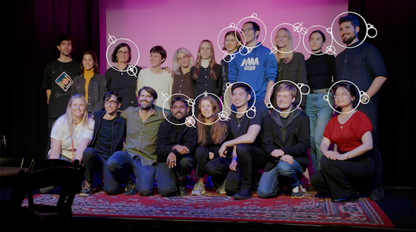 group of people standing on a stage with a carpet on the ground