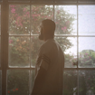 man facing a wall of windows